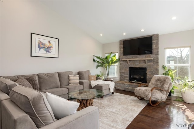 living room featuring recessed lighting, a fireplace, lofted ceiling, and wood finished floors