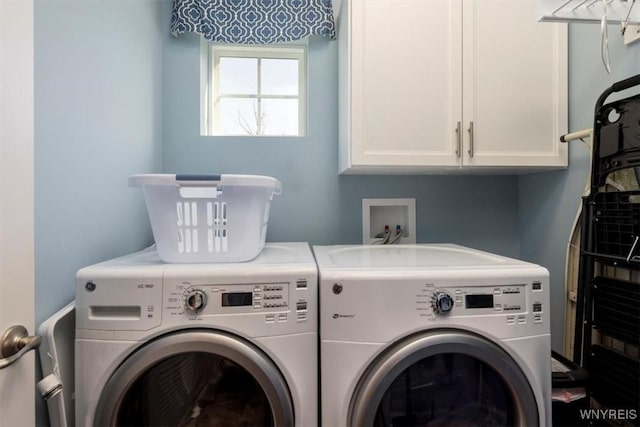 clothes washing area with washer and clothes dryer and cabinet space