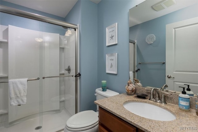 full bath featuring visible vents, vanity, toilet, and a shower stall