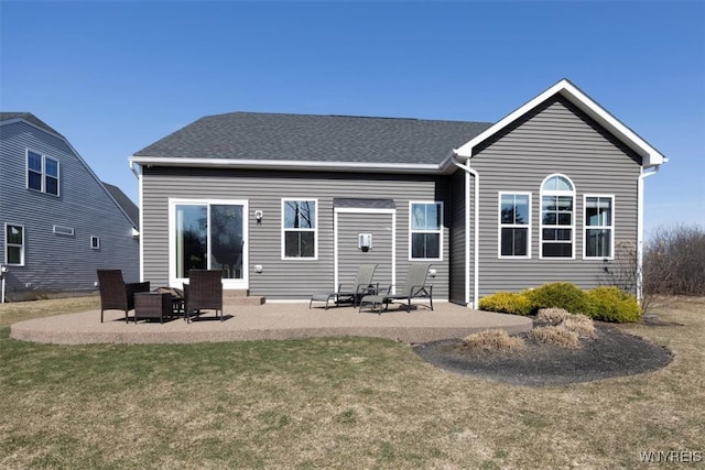 rear view of property with a yard and a patio