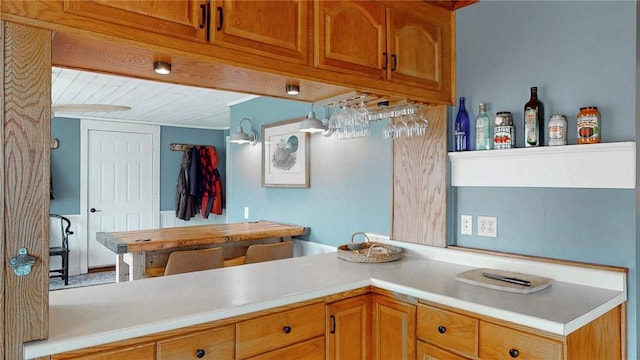 kitchen with light countertops and brown cabinets