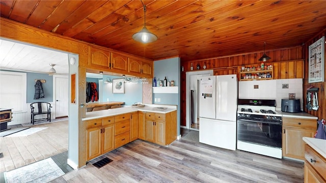 kitchen with a wood stove, white appliances, light wood-type flooring, light countertops, and wood ceiling