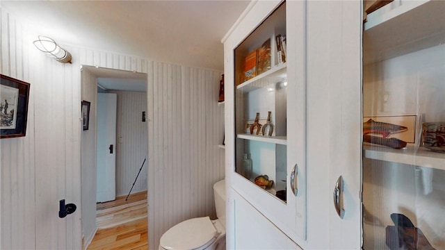 bathroom with toilet and wood finished floors