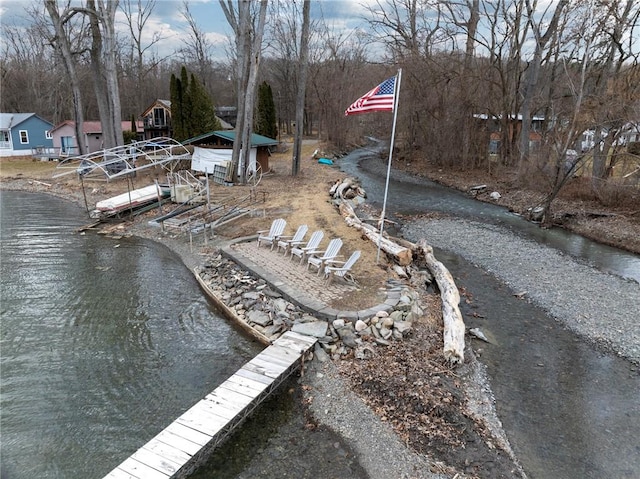 view of yard with a water view and a boat dock