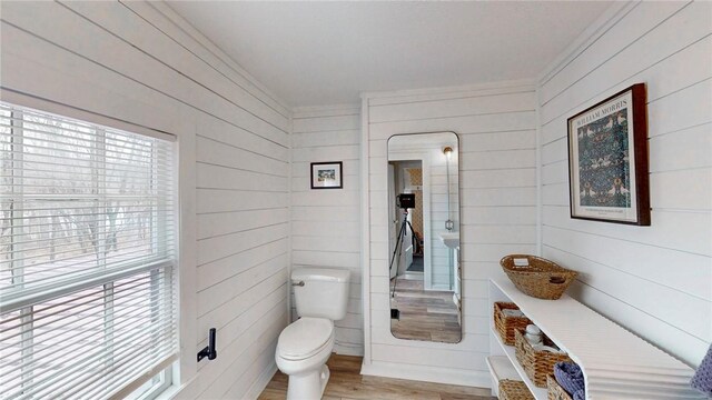 14838 W Lake Rd, Pulteney, NY 14418 - bathroom with crown molding, plenty of natural light, wood finished floors, and wooden walls