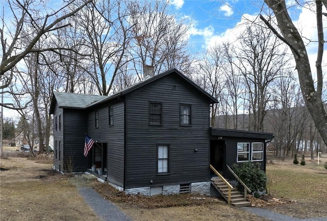 view of front facade featuring a chimney