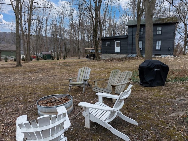 view of yard with a fire pit