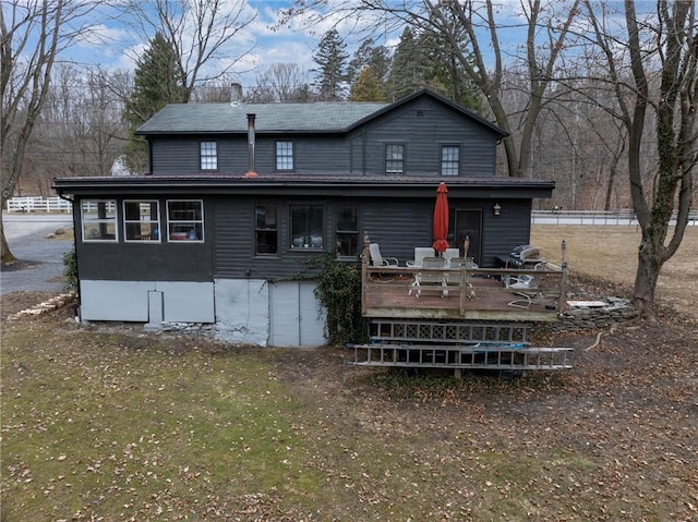 back of property with a wooden deck