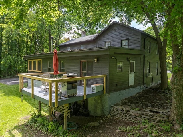 14838 W Lake Rd, Pulteney, NY 14418 - back of property featuring a wooden deck, a lawn, a chimney, and cooling unit