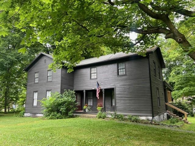 14838 W Lake Rd, Pulteney, NY 14418 - view of front of property with a front lawn and covered porch