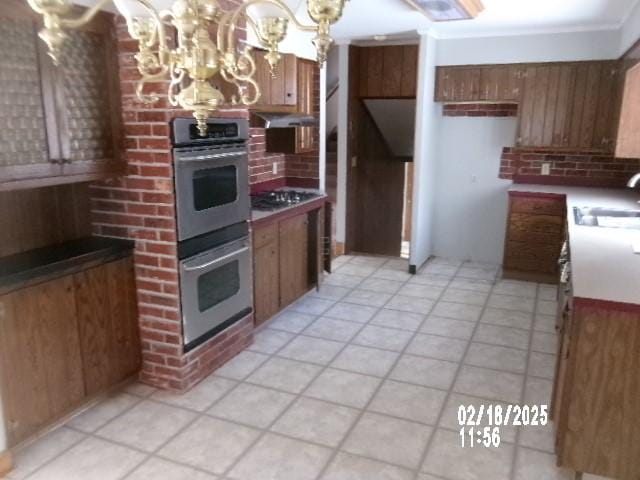 153 Holden Rd, Southport, NY 14871 - kitchen with a sink, a notable chandelier, brown cabinets, and stainless steel double oven