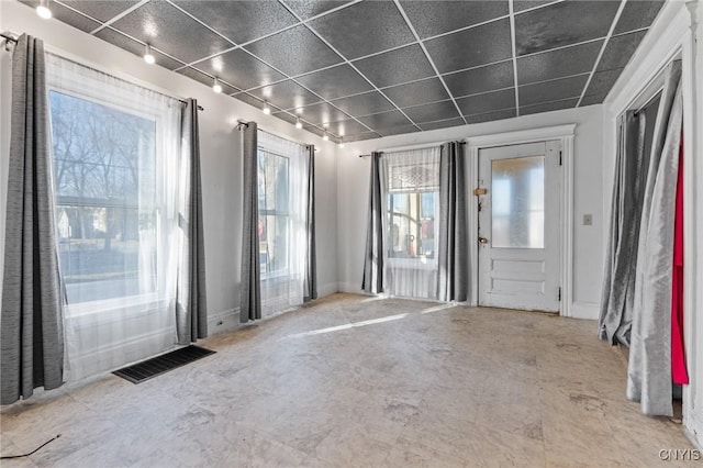 spare room with visible vents, track lighting, and baseboards