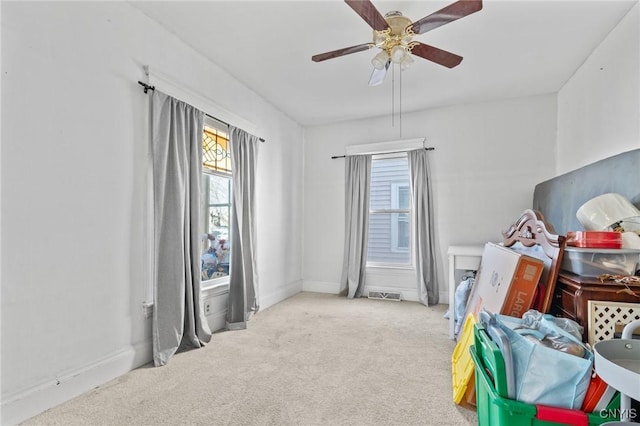 game room with visible vents, baseboards, ceiling fan, and carpet flooring