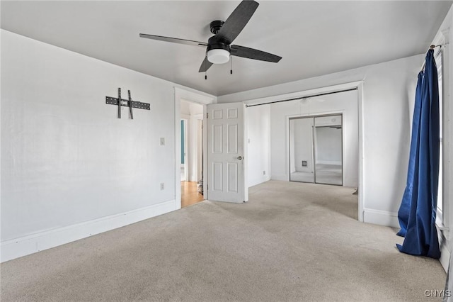 unfurnished bedroom featuring baseboards, carpet floors, and ceiling fan