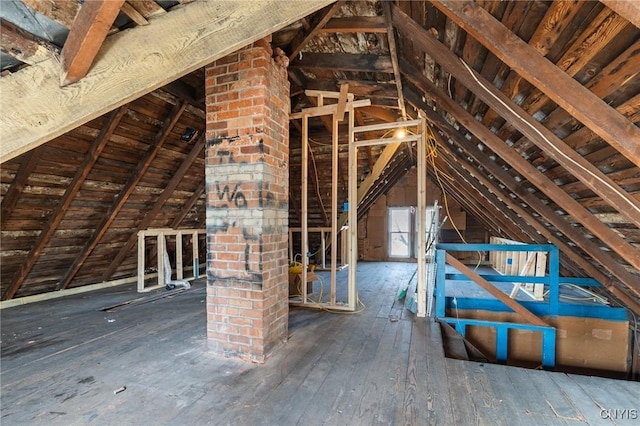 unfinished attic featuring an upstairs landing