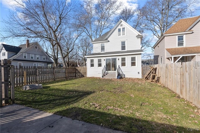 view of front of home with a fenced backyard, a front yard, and entry steps