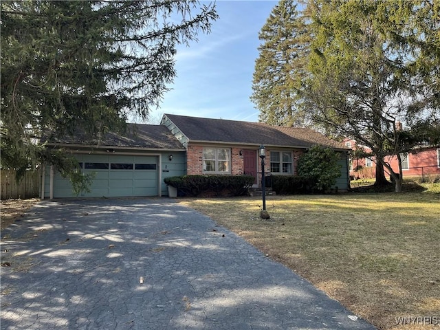 ranch-style home featuring aphalt driveway, fence, a front yard, an attached garage, and brick siding