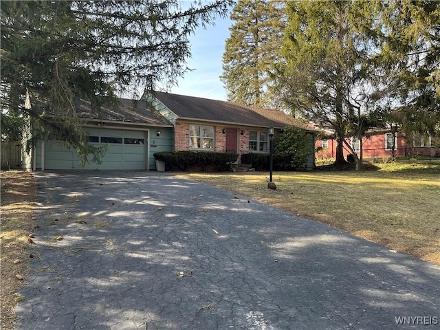 ranch-style home featuring a front yard, fence, a garage, and driveway