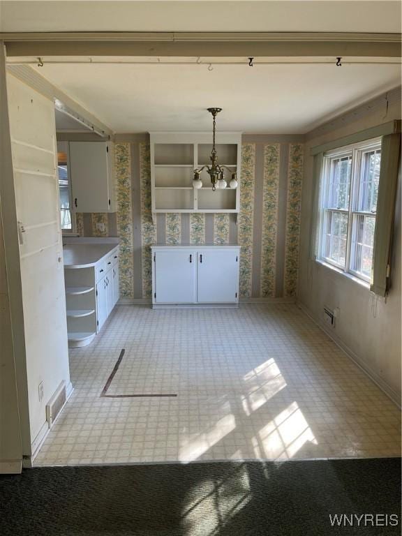 kitchen featuring white cabinetry, open shelves, a notable chandelier, and visible vents