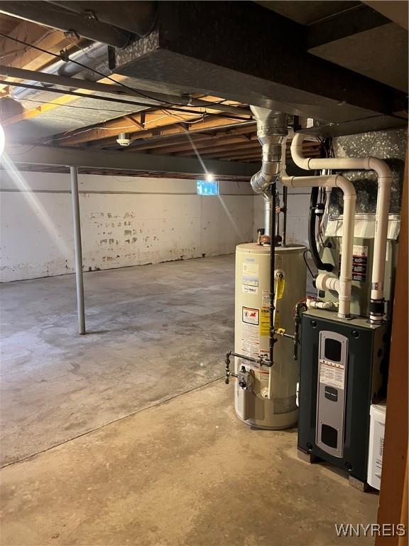 unfinished basement featuring gas water heater