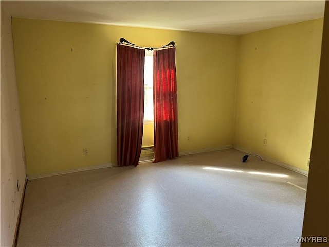 spare room featuring baseboards