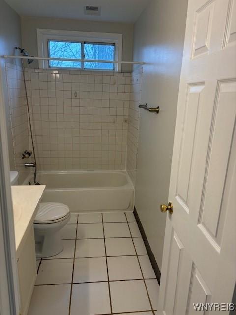 bathroom with vanity, washtub / shower combination, visible vents, tile patterned flooring, and toilet