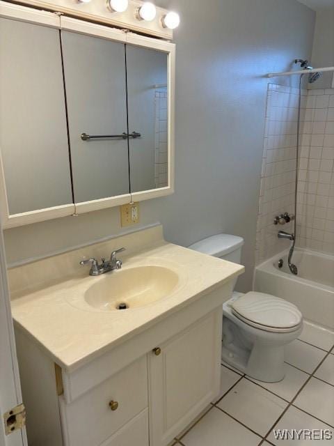 bathroom featuring tile patterned flooring, shower / washtub combination, toilet, and vanity