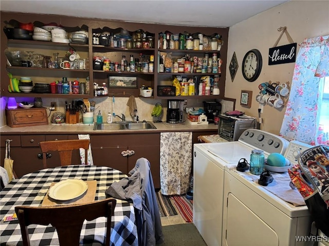 laundry room with a toaster, laundry area, independent washer and dryer, and a sink