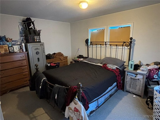 carpeted bedroom featuring a textured ceiling