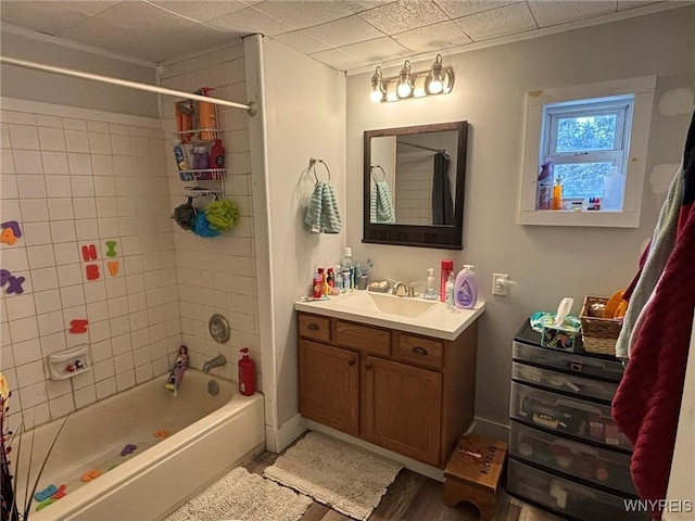 bathroom with shower / bath combination with curtain, vanity, baseboards, and wood finished floors