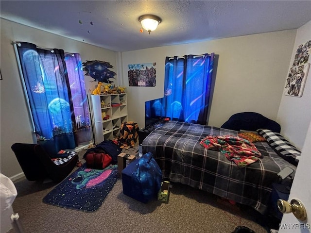 bedroom with carpet floors and a textured ceiling