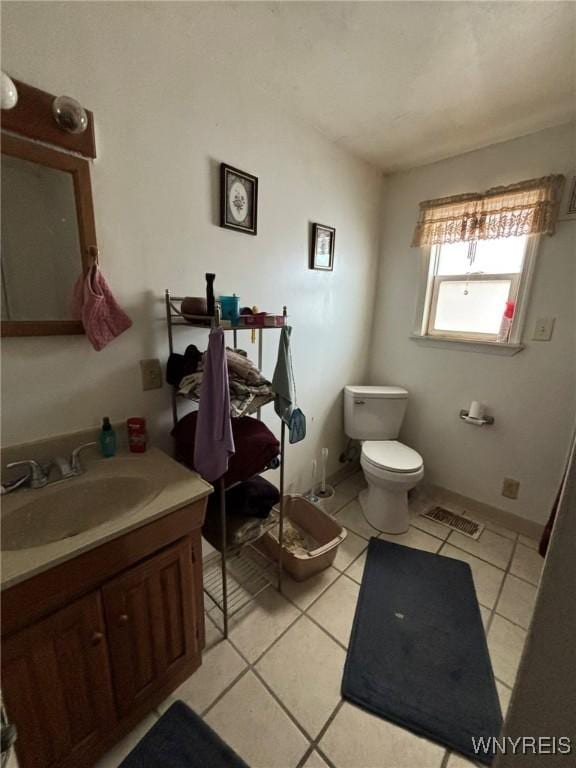 bathroom with tile patterned flooring, visible vents, toilet, and vanity