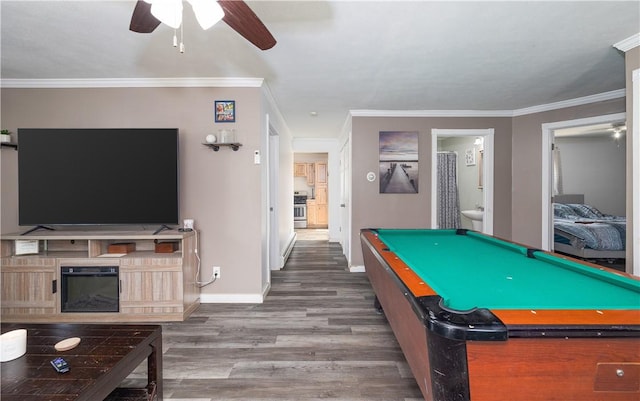 recreation room with crown molding, wood finished floors, baseboards, and ceiling fan