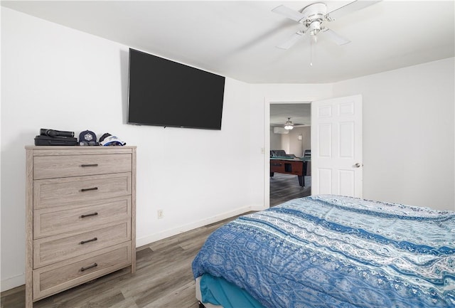 bedroom with wood finished floors, baseboards, and ceiling fan