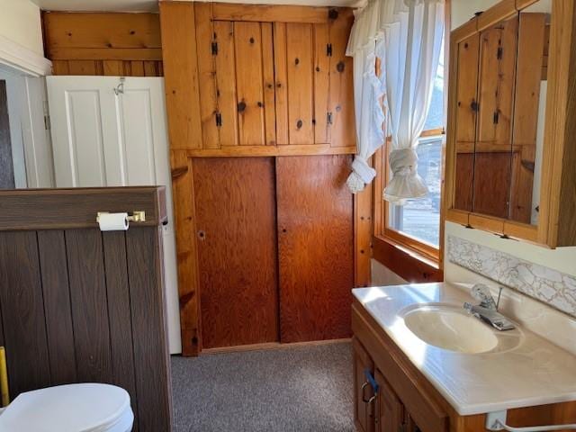 bathroom featuring toilet and vanity