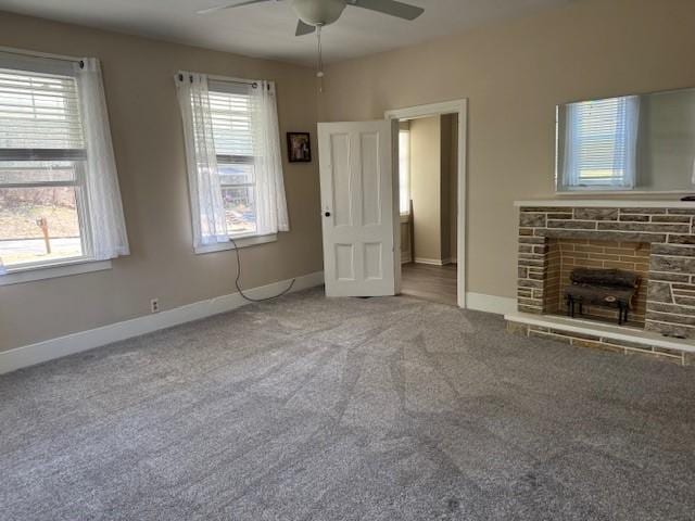 unfurnished living room with baseboards, carpet floors, a healthy amount of sunlight, and ceiling fan