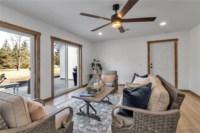 living area with visible vents, a ceiling fan, recessed lighting, light wood finished floors, and baseboards