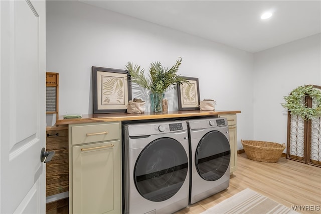 laundry room with recessed lighting, cabinet space, separate washer and dryer, light wood finished floors, and baseboards