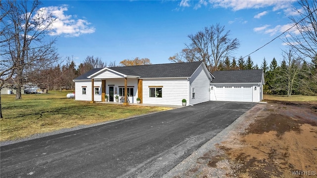 view of front of property featuring driveway, a front lawn, a porch, a shingled roof, and a garage