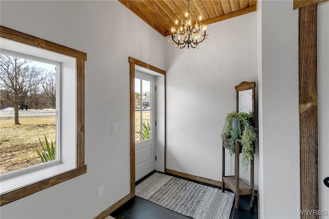 entrance foyer featuring wooden ceiling, baseboards, tile patterned floors, and a chandelier