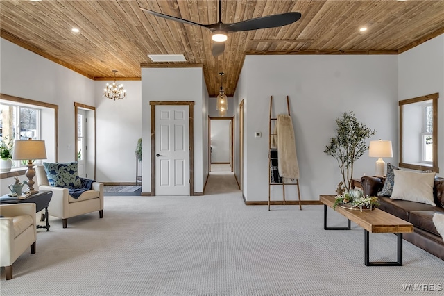 living room with a wealth of natural light, carpet, wood ceiling, and ceiling fan with notable chandelier