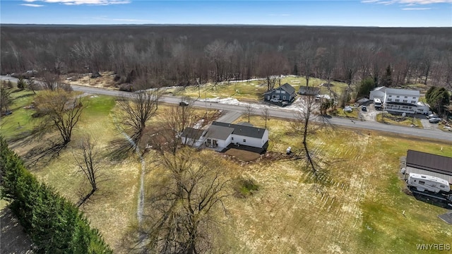 birds eye view of property with a view of trees