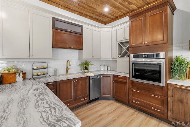 kitchen featuring a sink, tasteful backsplash, appliances with stainless steel finishes, wooden ceiling, and light stone countertops