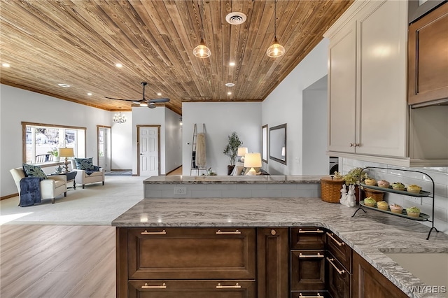 kitchen with light stone countertops, open floor plan, a peninsula, wooden ceiling, and a ceiling fan