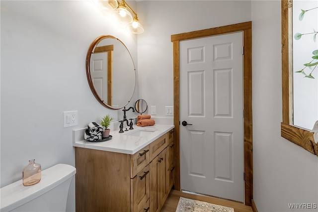 half bath with vanity and toilet