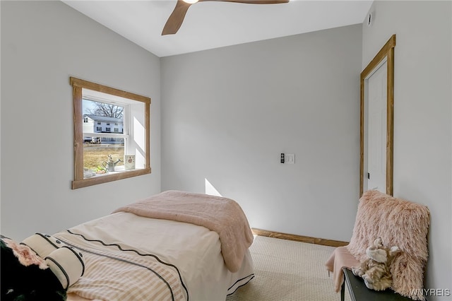 carpeted bedroom featuring baseboards and ceiling fan