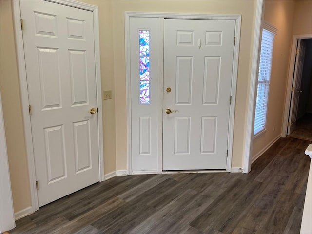 entrance foyer featuring dark wood finished floors and baseboards