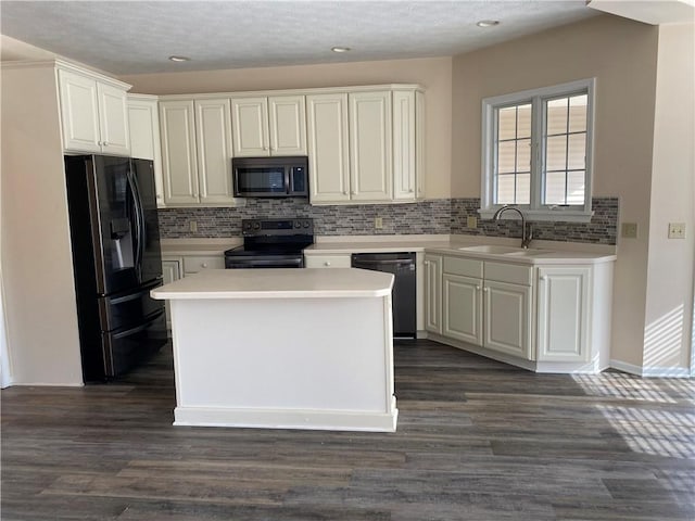 kitchen featuring a sink, decorative backsplash, appliances with stainless steel finishes, and light countertops