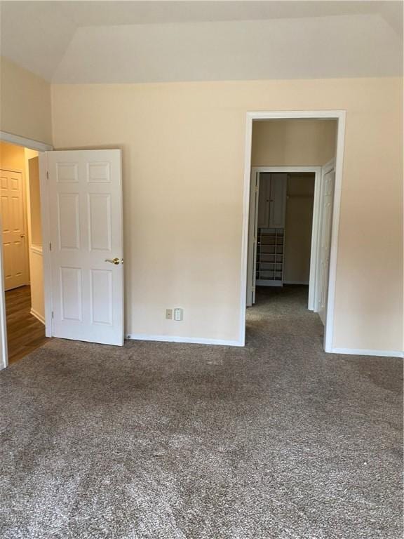 carpeted spare room featuring baseboards