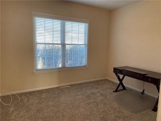 unfurnished room featuring baseboards, visible vents, and carpet floors